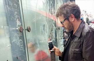 Julien Tatham working in photography with a mobile phone for "Us Stop"