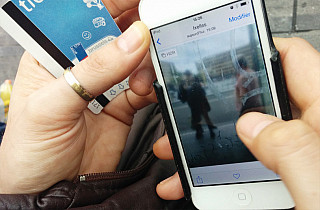 Julien Tatham working in photography with a mobile phone for "Us Stop"